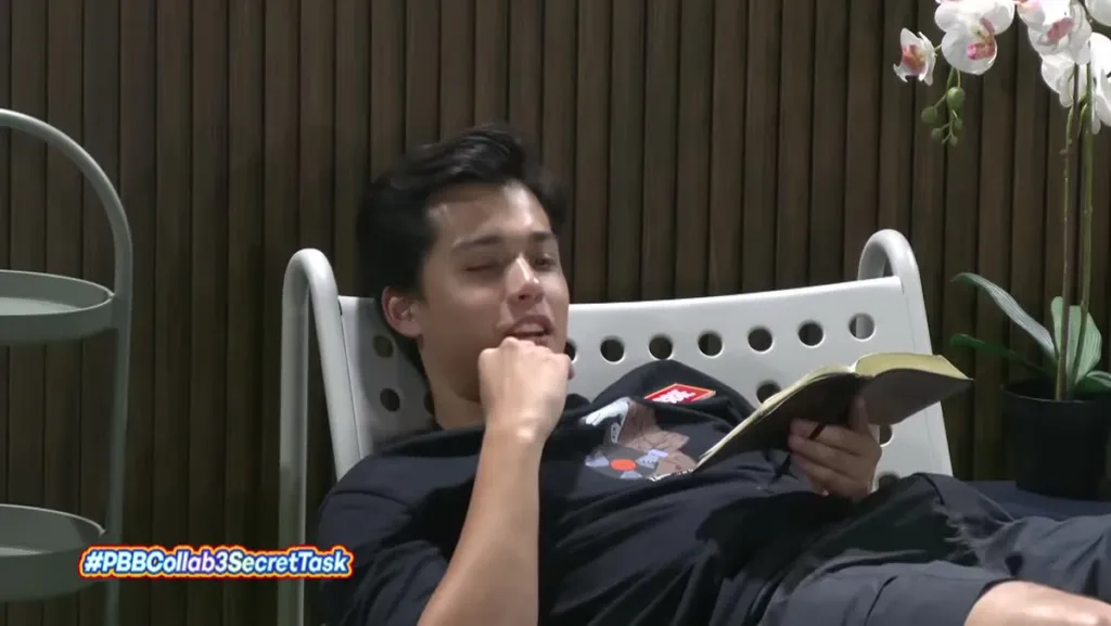 Robbie ng PBB Collab 3.0 na nagbabasa ng Bible sa garden